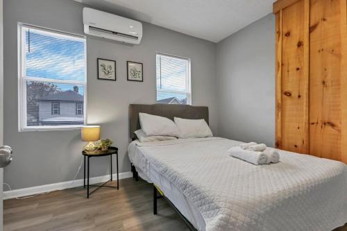 a bedroom with a bed with a white bedspread at Modern Columbus 2BR Near COSI & Arena District in Columbus