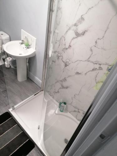 a bathroom with a shower and a sink at Regent Cosy Homes in Stoke on Trent