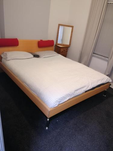 a bedroom with a bed with a mirror and a mirror at Regent Cosy Homes in Stoke on Trent