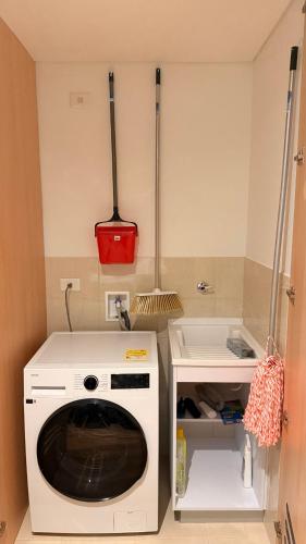 a kitchen with a washing machine and a sink at Teusaquillo Urban Loft in Bogotá