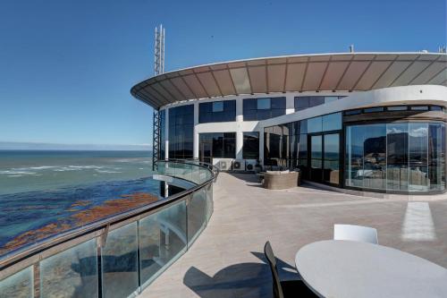 a building with a balcony with a view of the ocean at Ocean View Penthouse in Strand