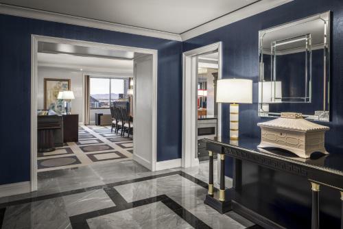 a living room with blue walls and a table with a lamp at Caesars Palace Hotel & Casino in Las Vegas