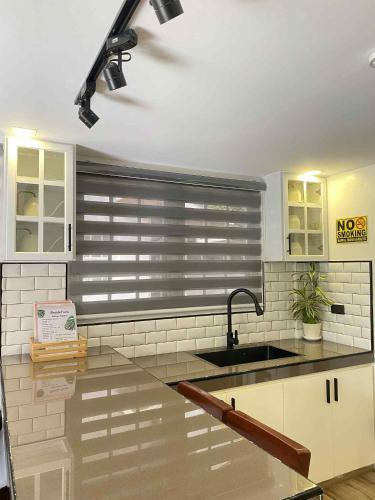a kitchen with a sink and a window at Benido Farm - A Secret Haven in San Jose