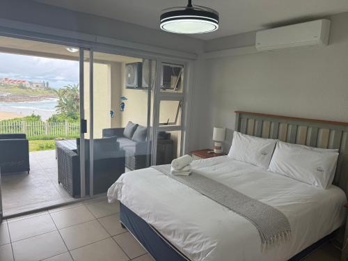 a bedroom with a bed and a view of the ocean at 37 Laguna La Crete in Margate