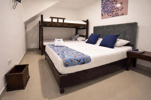 a bedroom with a bed and a bunk bed at Open Sea Hotel Cartagena - Frente al mar in Cartagena de Indias