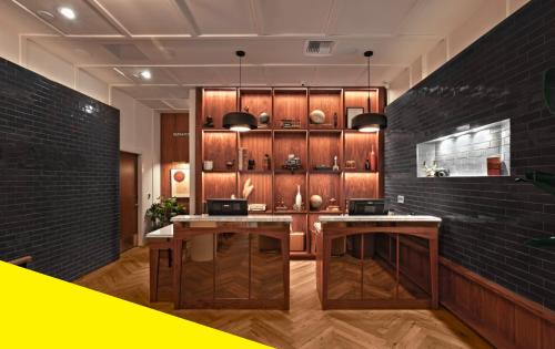 a kitchen with wooden cabinets and two tables at Bposhtels San Francisco in San Francisco