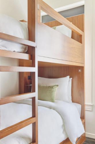 a bedroom with bunk beds with white pillows at Bposhtels San Francisco in San Francisco