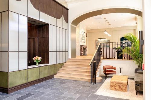 a lobby with a staircase in a building at Hotel Heron Alexandria Old Town, Curio Collection by Hilton in Alexandria