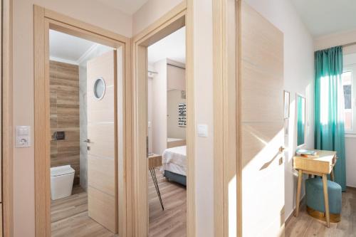 a room with a door leading to a bedroom at Erato by Vintage Travel in Tsoukalades