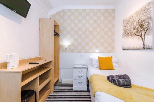 a small bedroom with two beds and a desk at Blackpool Lodge in Blackpool