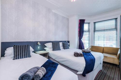 a bedroom with two beds and a window at Blackpool Lodge in Blackpool
