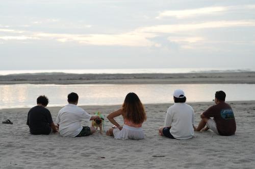 a group of people sitting on the beach at AmanDagat Beach Resort in Sindol