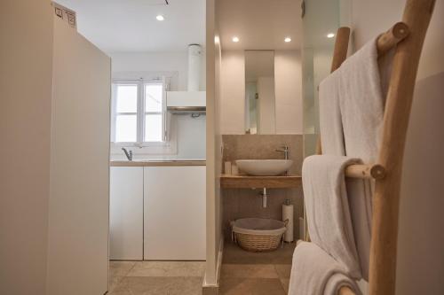 a bathroom with a sink and a toilet and a mirror at Can Savella - Turismo de Interior in Palma de Mallorca