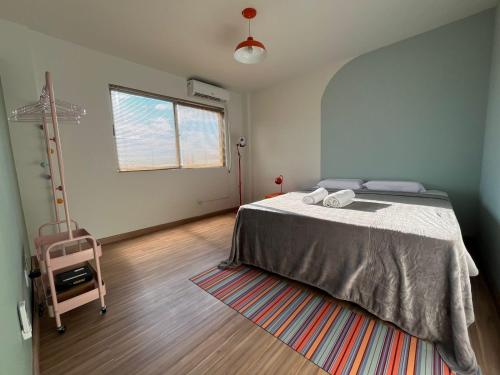 a bedroom with a bed and a rug at Ed Las Vegas by Select Stays in Chapecó
