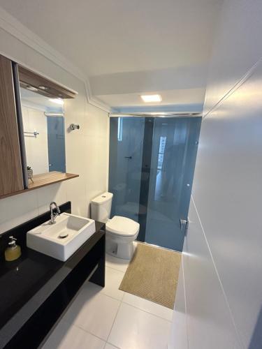 a bathroom with a sink and a toilet and a shower at Ed Las Vegas by Select Stays in Chapecó