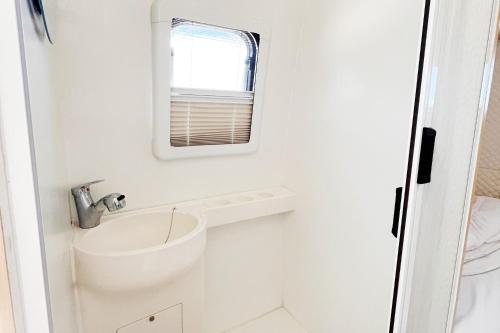 a small bathroom with a sink and a mirror at Seaside Cenang in Pantai Cenang