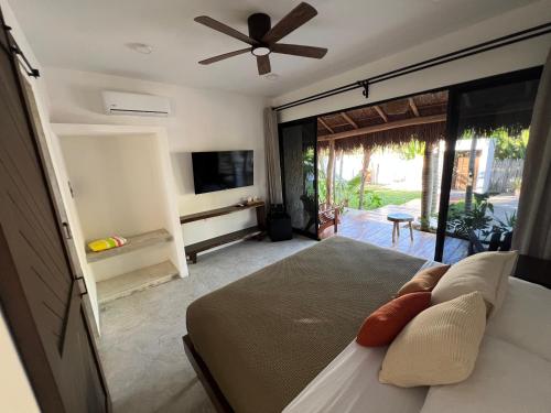a bedroom with a bed and a ceiling fan at Nomads Kite House in El Cuyo