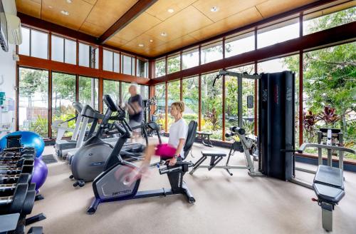 a gym with two people exercising on treadmills at Allisee Apartments in Gold Coast