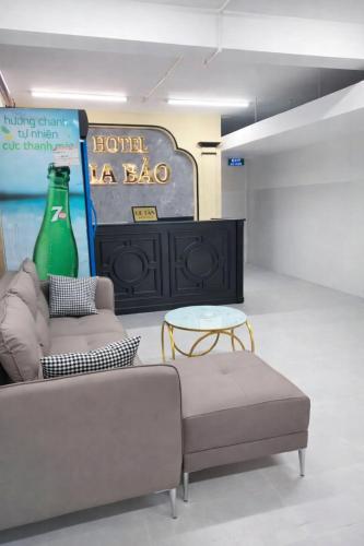 a room with a couch and a table and a bottle at Gia Bảo Hotel Thủ Đức in Ho Chi Minh City