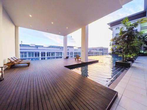 a large building with a large deck with a pool at Luxury Condominium at Loft Imago in Kota Kinabalu