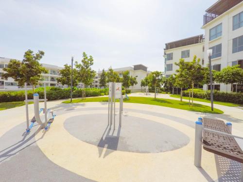 a park with benches and trees and buildings at Luxury Condominium at Loft Imago in Kota Kinabalu