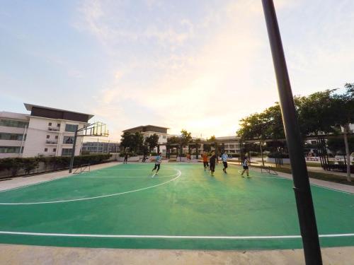 a group of people playing basketball on a basketball court at Luxury Condominium at Loft Imago in Kota Kinabalu
