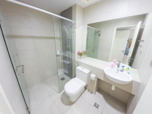 a bathroom with a toilet and a sink and a shower at Luxury Condominium at Loft Imago in Kota Kinabalu
