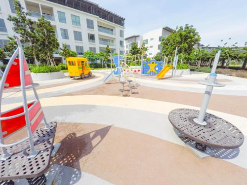 a playground with swings and slides in a park at Luxury Condominium at Loft Imago in Kota Kinabalu
