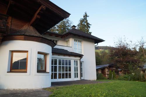 a white house with a large window at Villa Kitzbühel in Kirchberg in Tirol
