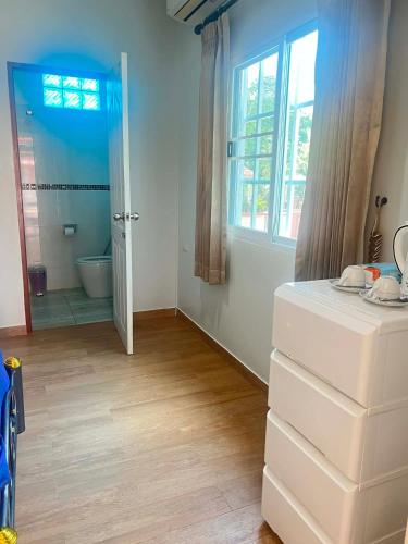 a room with a bathroom with a tub and a sink at Baan Phakdee in Ban Phlong Takhe