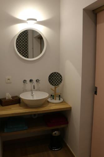 a bathroom with a sink and a mirror at Un Air de Château in Spa