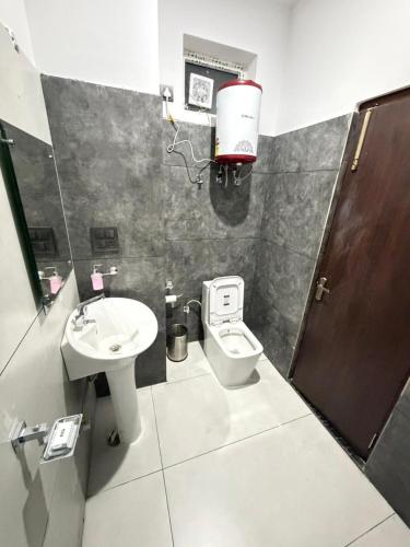 a bathroom with a toilet and a sink at Dual Lake in Bhīm Tāl