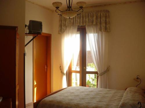 Postel nebo postele na pokoji v ubytování Agriturismo Zì Carmine