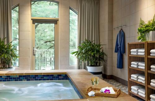 a jacuzzi tub in a room with a window at Mokara Hotel & Spa in San Antonio