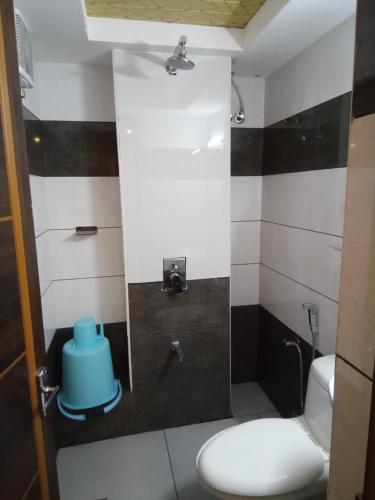 a bathroom with a toilet with a blue bowl on it at GRACE RESIDENCY in Tirūr
