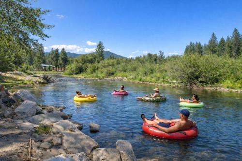 a group of people tubing down a river in tubes at Riverwood Lodge in Leavenworth