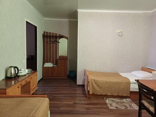 a hotel room with two beds and a mirror at Hotel Gostynnyi Dvir in Sharhorod