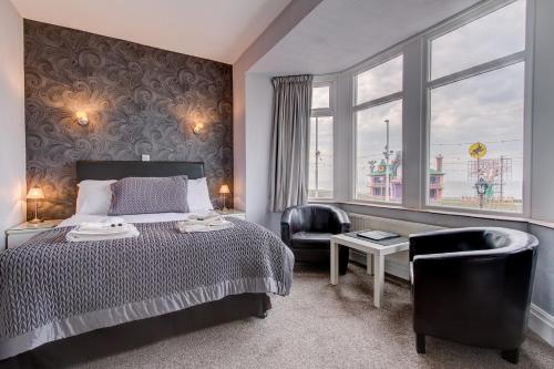 a bedroom with a bed and a chair and a window at Windsor Park promenade in Blackpool