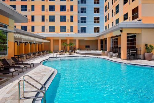 a swimming pool in the middle of a building at Hyatt House across from Universal Orlando Resort in Orlando