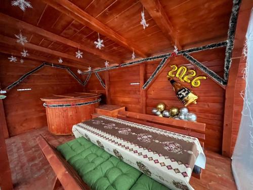 a room with a bed in a wooden room at Cabana Paltini in Costeşti