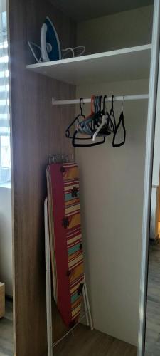 a room with a closet with a suitcase and hangers at Apartament Lipnicki 2 in Bielsko-Biała