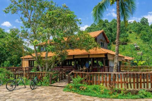 a house with bikes parked in front of it at Dream Hill Homestay in Cat Tien