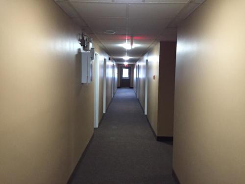 a hallway in an office building with a long corridor at Nights Inn Motel in Thunder Bay