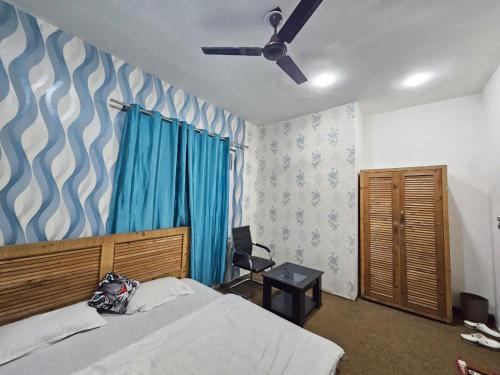 a bedroom with a bed and a ceiling fan at Green Resort in Rājbāgh