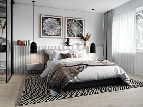 a white bedroom with a bed and a rug at Pousada x in São Paulo