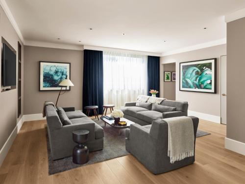 a living room with two couches and a table at 11 Howard, New York, a Member of Design Hotels in New York