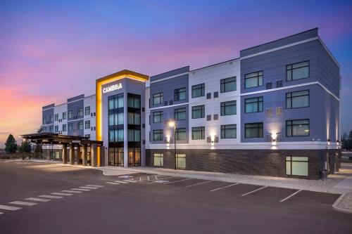 a large white building with a parking lot at Cambria Hotel Spokane Airport in Spokane