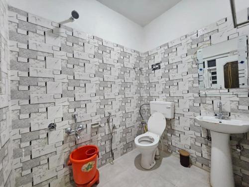 a bathroom with a toilet and a sink at Green Resort in Rājbāgh