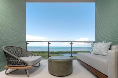 a room with a couch and a chair and a window at Grand Hyatt Cancun Beach Resort in Cancún