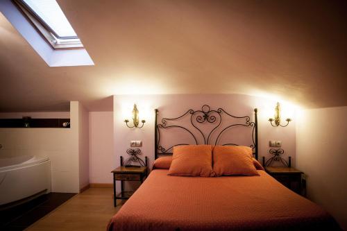 a bedroom with a bed with an orange bedspread at Pensión Ametzagaña in Donostia-San Sebastián